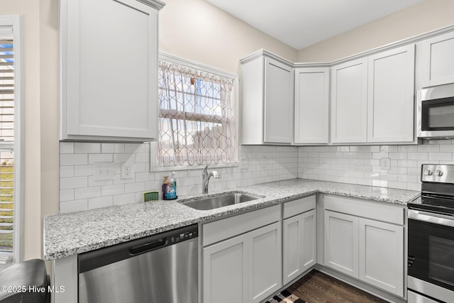 kitchen featuring white cabinetry, sink, and appliances with stainless steel finishes