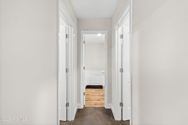 hallway with dark carpet