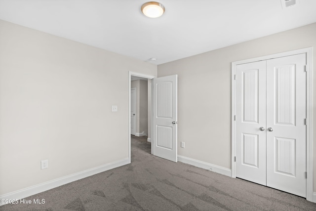 unfurnished bedroom featuring carpet flooring and a closet