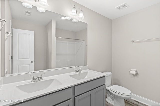 bathroom with vanity, wood-type flooring, walk in shower, and toilet