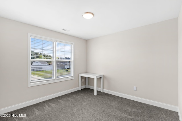 unfurnished room featuring carpet