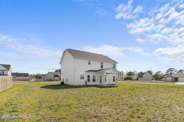 rear view of house featuring a lawn