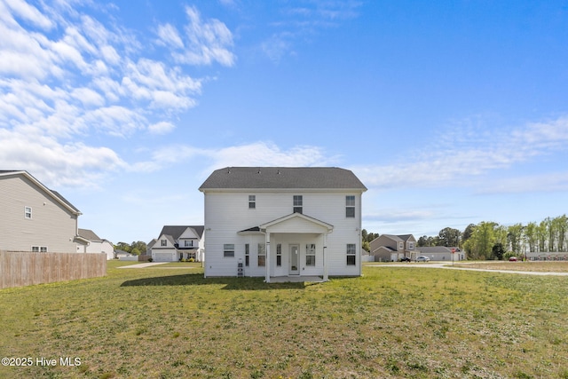 back of house with a yard