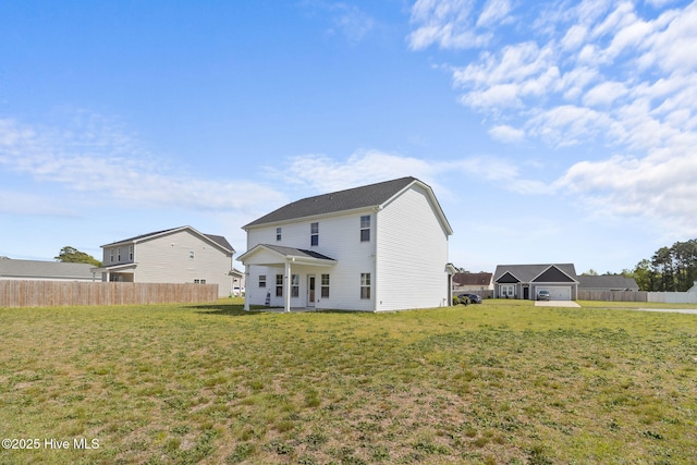 rear view of property with a lawn