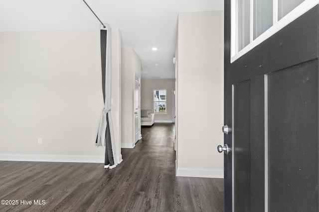 hallway with dark hardwood / wood-style flooring