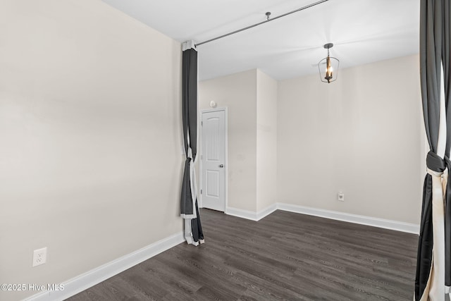 spare room featuring dark wood-type flooring