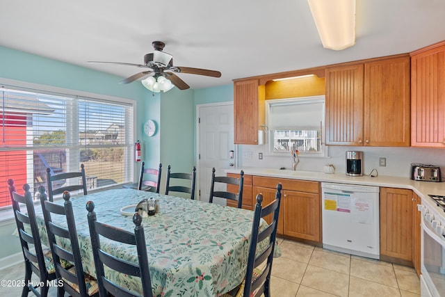 kitchen with ceiling fan, sink, light tile patterned flooring, and white appliances