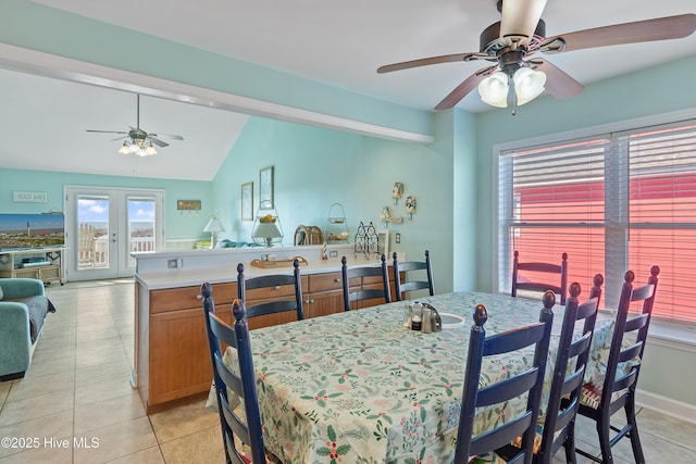 tiled dining room with ceiling fan, french doors, and lofted ceiling