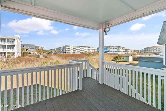 deck with a yard and a storage shed