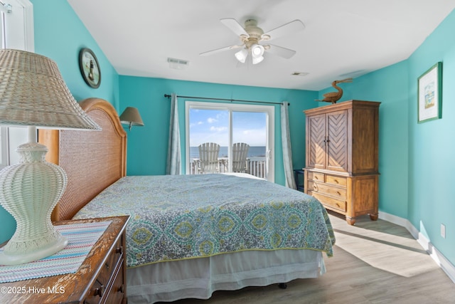 bedroom with hardwood / wood-style floors, access to outside, and ceiling fan