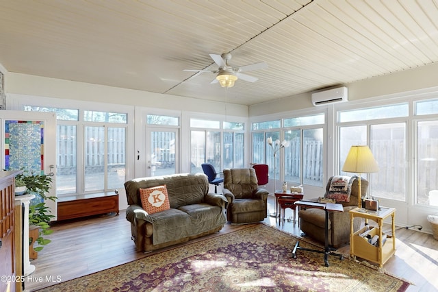 sunroom featuring an AC wall unit, ceiling fan, and wood ceiling