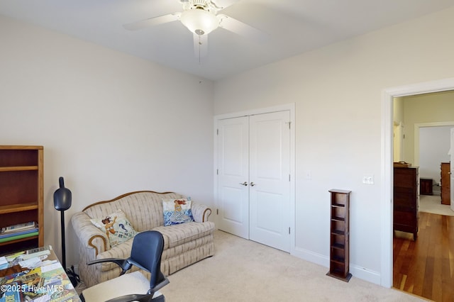 sitting room featuring ceiling fan and light colored carpet