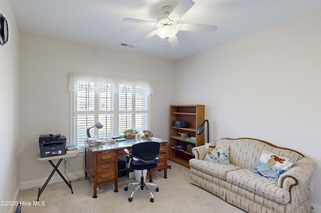 carpeted office space featuring ceiling fan