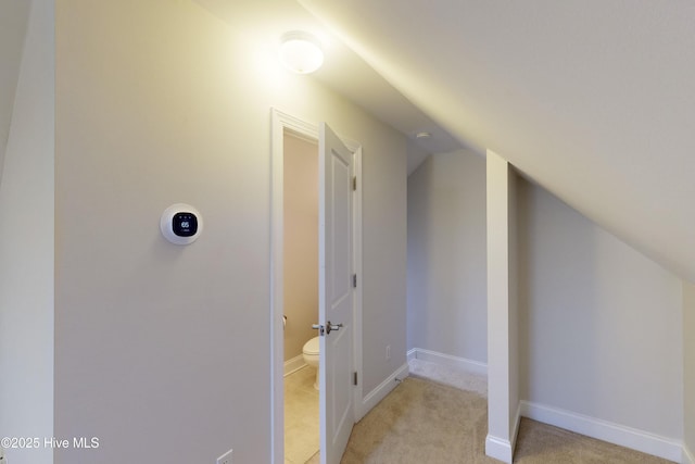 bonus room featuring light colored carpet and vaulted ceiling