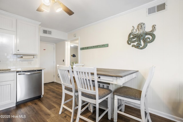 dining area with ceiling fan, dark hardwood / wood-style flooring, ornamental molding, and sink