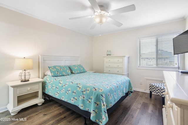 bedroom with dark hardwood / wood-style flooring, ceiling fan, and crown molding