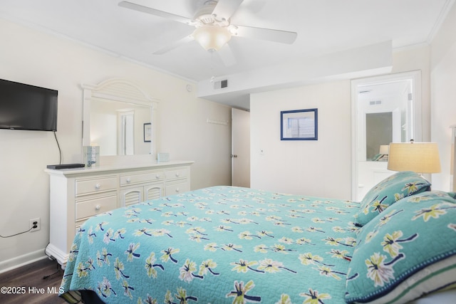 bedroom with ceiling fan, ornamental molding, and dark wood-type flooring