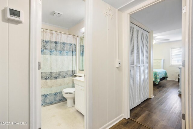 bathroom with vanity, hardwood / wood-style flooring, toilet, and walk in shower