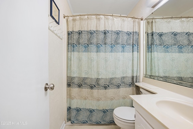 bathroom with vanity, curtained shower, toilet, and ornamental molding