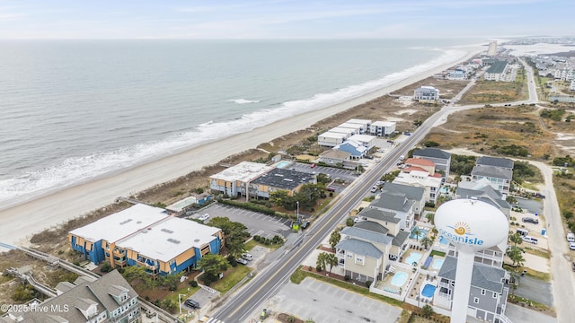 bird's eye view with a water view and a beach view