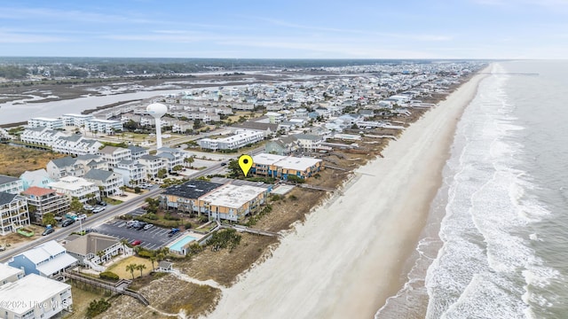 drone / aerial view with a water view and a beach view