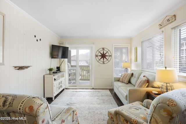 living room featuring wood walls and ornamental molding