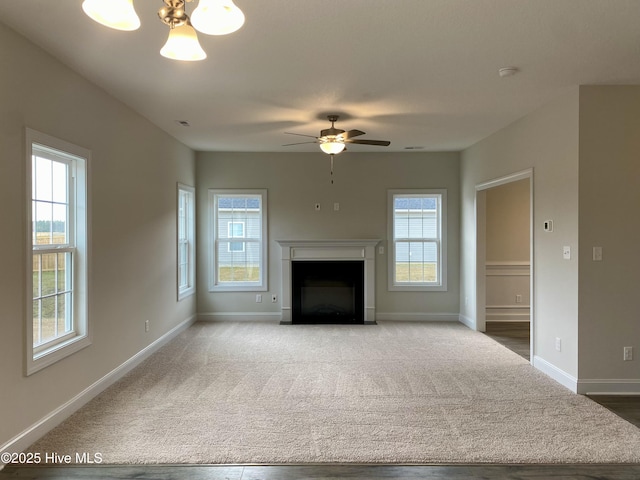 unfurnished living room featuring ceiling fan and carpet