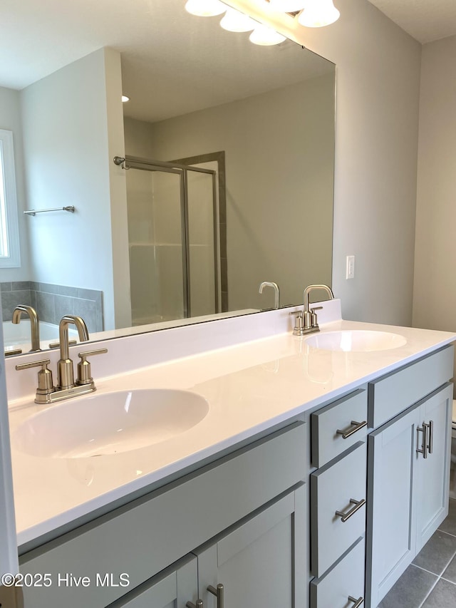 bathroom with tile patterned flooring, vanity, and a shower with shower door