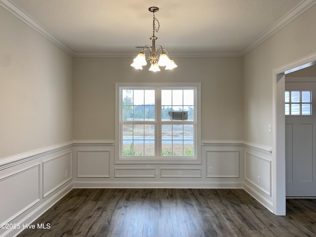 unfurnished dining area with crown molding, dark hardwood / wood-style flooring, and a chandelier