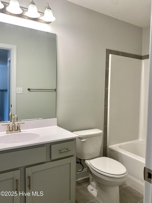 full bathroom with tile patterned floors, vanity, bathing tub / shower combination, and toilet