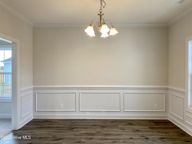 unfurnished room with dark wood-type flooring, a chandelier, and ornamental molding