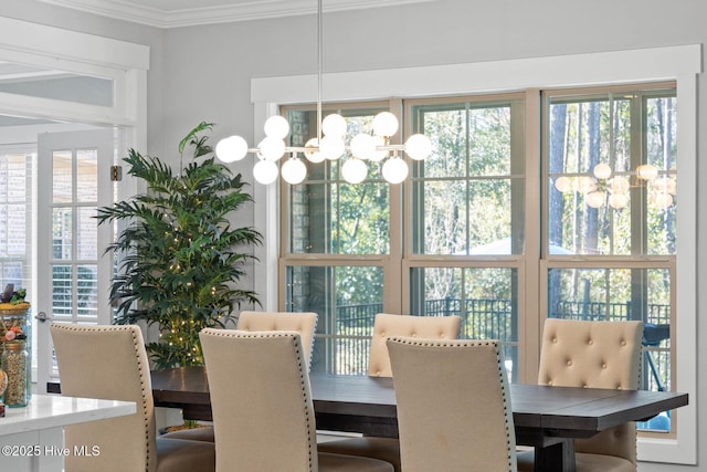 dining area with a chandelier and ornamental molding