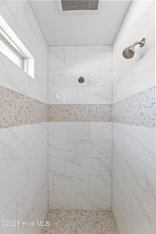 bathroom with tiled shower