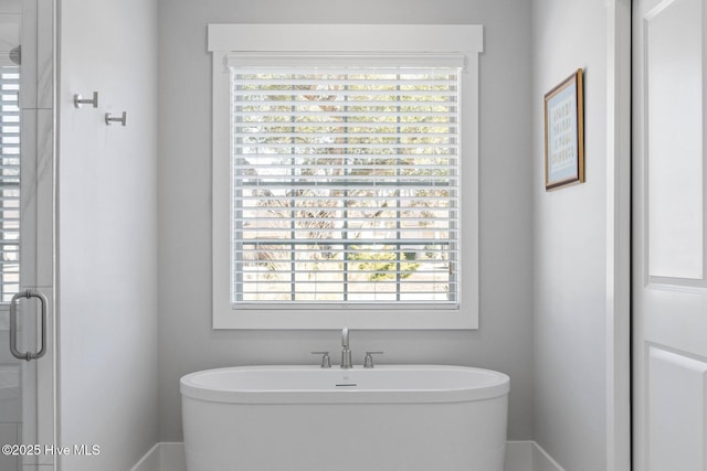 bathroom with plenty of natural light and shower with separate bathtub