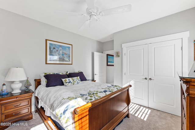 bedroom featuring ceiling fan, a closet, and carpet floors