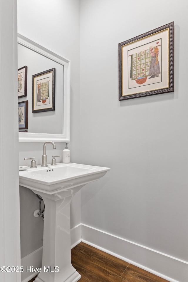 bathroom with hardwood / wood-style floors and sink