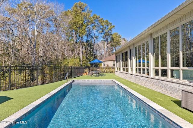 view of pool featuring a yard