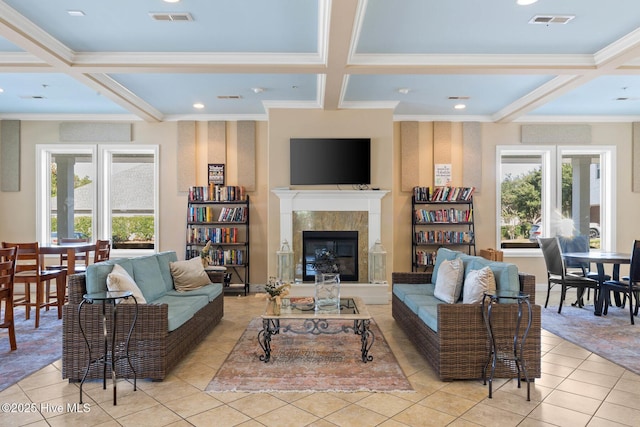 tiled living room with ornamental molding, coffered ceiling, a tile fireplace, and beamed ceiling