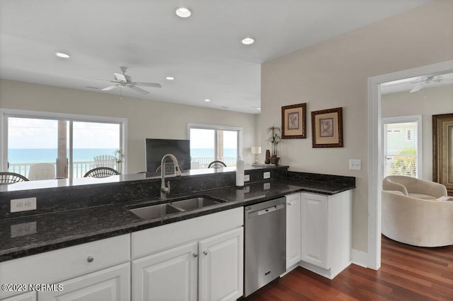 kitchen featuring white cabinets, dishwasher, sink, and dark stone counters