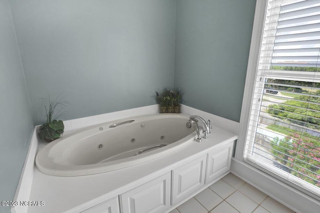 bathroom with tile patterned floors and a bathtub