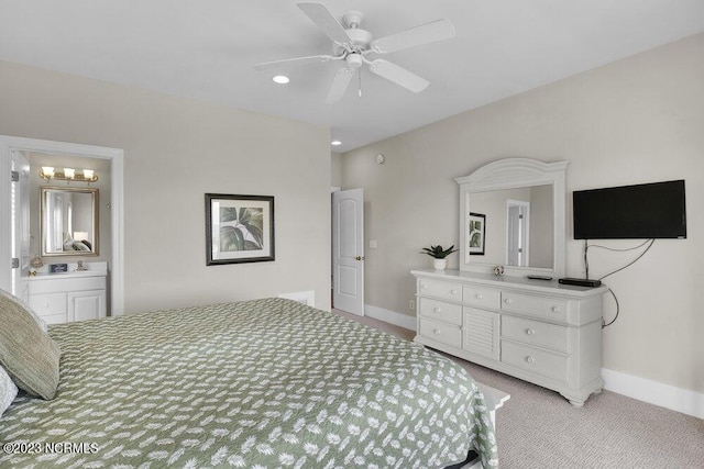 bedroom featuring ceiling fan, light carpet, and ensuite bath