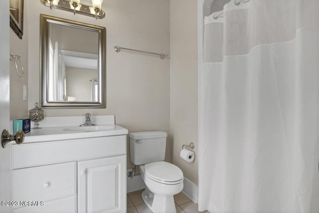 bathroom with tile patterned floors, vanity, and toilet