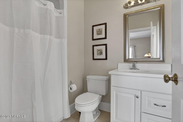 bathroom with tile patterned flooring, vanity, and toilet