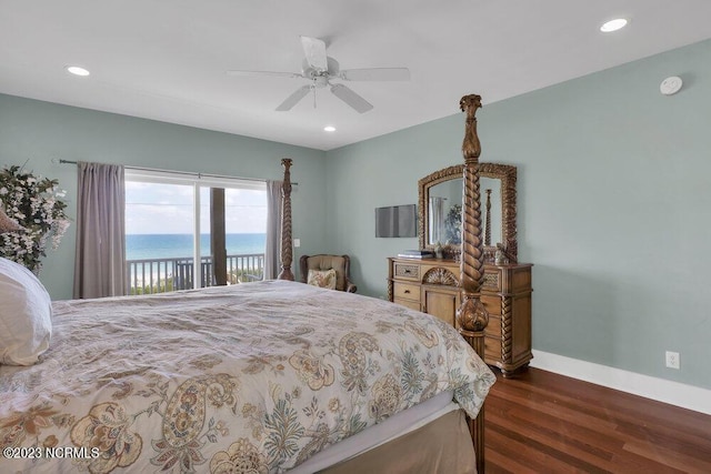 bedroom featuring access to exterior, a water view, ceiling fan, and dark hardwood / wood-style floors