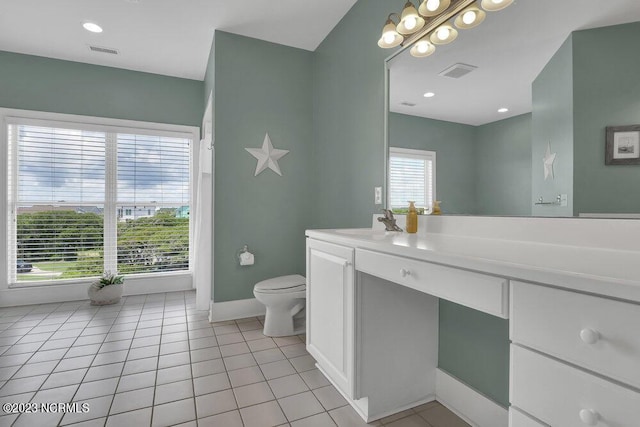 bathroom featuring tile patterned flooring, vanity, and toilet