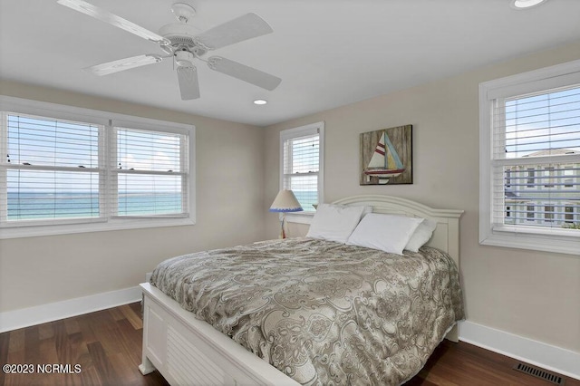 bedroom featuring ceiling fan and dark hardwood / wood-style floors