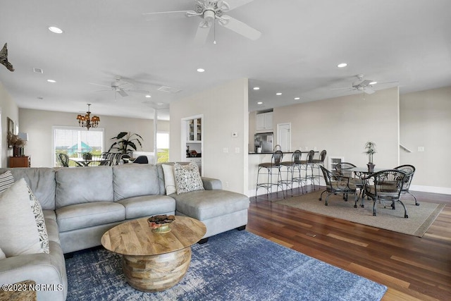 living room featuring dark hardwood / wood-style floors and an inviting chandelier