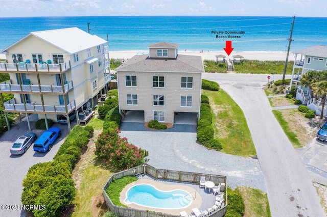 drone / aerial view featuring a beach view and a water view