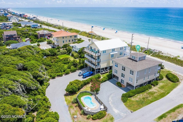 birds eye view of property featuring a view of the beach and a water view