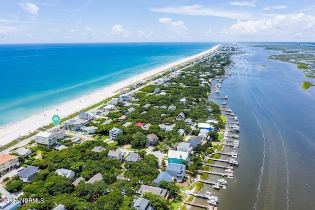 birds eye view of property featuring a water view and a beach view